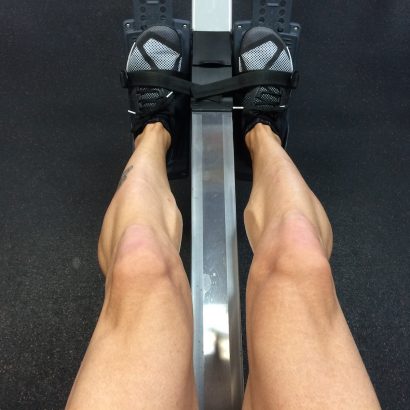 person sitting on rowing machine