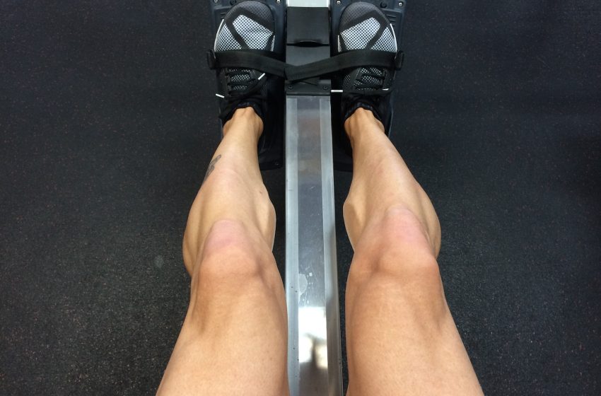 person sitting on rowing machine