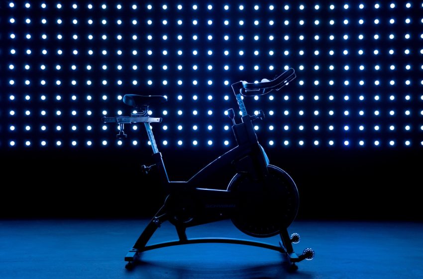 a stationary exercise bike in front of a blue background